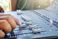Hand adjusting audio mixer console buttons, faders and sliders. Royalty Free Stock Photo