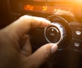 A hand is adjusting level temperature control button of air condition. Royalty Free Stock Photo