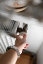 A hand adjusting a radiator valve in a home interior. The image represents heating control, energy saving, and household Royalty Free Stock Photo