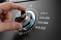 Hand adjusting a security dial to SHA 224 encryption level for enhanced data protection and privacy Royalty Free Stock Photo