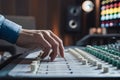 Hand adjusting sound mixer knob in recording studio, audio engineering Royalty Free Stock Photo