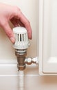 Hand Adjusting Thermostat On Radiator Valve Royalty Free Stock Photo