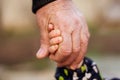 Hand of an adult man holding tightly child hand. Family connection, kid safety, protection and anti kidnap concept