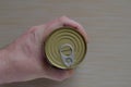 Hand of an adult man holds a can of canned food Royalty Free Stock Photo
