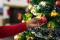 Hand of african american senior woman decorating christmas tree Royalty Free Stock Photo