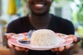 Hand of african man holding a white rice in the plate Royalty Free Stock Photo
