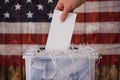 A hand places a transparent ballot into a ballot box. created with Generative AI technology Royalty Free Stock Photo