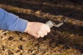 the hand of an aggressive male criminal in blue clothes holds a sharp piece of glass broken bottle Royalty Free Stock Photo