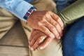 hand in hand through it all. an unrecognizable senior couple holding hands together while sitting on a couch at home. Royalty Free Stock Photo