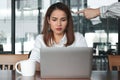 Hand of angry boss pointing anxious stressed Asian business woman in office