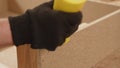 Hand applying glue to wooden joints