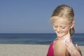 Hand Applying Sunscreen To Girl On Beach