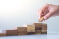 Hand aranging wood block stacking as step stair. Royalty Free Stock Photo