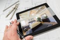 Hand of Architect on Computer Tablet Showing Bedroom Over House