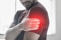 Hand, arm pain and injury with a man shoulder in red highlight during a fitness workout. Healthcare, medical and anatomy