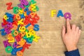 Hand arrange plastic letters as FAQ abbreviation
