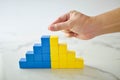 Hand arranging color wood block stacking as step stair. Business concept for growth success process on white background. Royalty Free Stock Photo