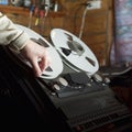 Hand arranging a tape in a reel-to-reel recorder Royalty Free Stock Photo