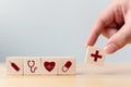 Hand arranging wood block cube shape with icon healthcare medical