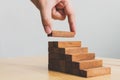 Hand arranging wood block stacking as step stair Royalty Free Stock Photo