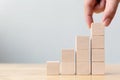 Hand arranging wood block stacking as step stair. Ladder career path concept Royalty Free Stock Photo