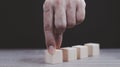 Hand arranging wood block stacking as step stair on wooden table. Business concept for growth success process. Copy space Royalty Free Stock Photo