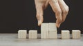 Hand arranging wood block stacking as step stair on wooden table. Business concept for growth success process. Copy space Royalty Free Stock Photo