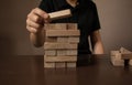 Hand arranging wood block stacking as step stair on wooden table. Business concept for growth success Royalty Free Stock Photo