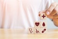 Hand arranging wood block stacking with icon healthcare medical Royalty Free Stock Photo