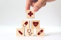 Hand arranging wood block stacking with icon healthcare medical Royalty Free Stock Photo