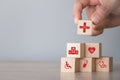 Hand arranging wood block stacking with icon healthcare medical Royalty Free Stock Photo