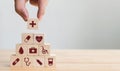 Hand arranging wood block stacking with icon healthcare medical, Insurance Royalty Free Stock Photo