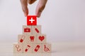 Hand arranging wood block stacking with icon healthcare medical, Insurance for your health concept Royalty Free Stock Photo