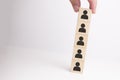 Hand arranging wooden blocks stacking as a column on white background Royalty Free Stock Photo