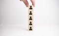 Hand arranging wooden blocks stacking as a column on white background Royalty Free Stock Photo