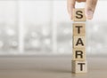 Hand arranging wooden blocks with the word START. Start, Start up, new career or new business, mindset concept Royalty Free Stock Photo