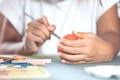 Hand of asian child girl drawing and painting on easter egg Royalty Free Stock Photo