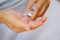 The hand of an asian elderly female, or senior person or an old woman hold a cup of medicine or pouring medicine on hand. Royalty Free Stock Photo