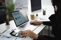 Hand of an Asian employee is calculating numbers on the office workspace Royalty Free Stock Photo