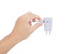 Hand of asian man is hold show of adapter charger for smartphone on white background Royalty Free Stock Photo