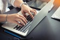 Hand of asian men using laptop keyboard with English and Thai alphabets on black table at home office .selective focus Royalty Free Stock Photo