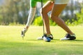 Hand asian sporty woman putting golf ball on tee with club in golf course on evening on time for healthy sport. Royalty Free Stock Photo