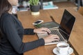 Hand of Asian Student typing report and research in library.Business woman working on laptop.Beautiful young freelancer writing Royalty Free Stock Photo