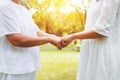 Hand of asian woman elderly giving fist bump to hands young women at outdoor in sunset Royalty Free Stock Photo