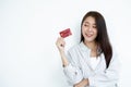 The hand of an Asian woman holding a credit card is used for online shopping and Internet payments