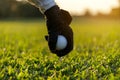 Hand asian woman putting golf ball on tee with club in golf course on sunny day for healthy sport. Royalty Free Stock Photo