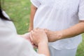 Hand of asian women holding elderly hands while walking at park,Senior taking care concept