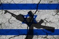 Hand assault rifle on the background of the flag of Israel and cracks. Israel Power Concept