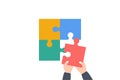 Hand assembling together jigsaw puzzle pieces. Businessman arm putting puzzle pieces together. Concept of missing link of project