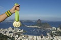 Hand of Athlete Holding Gold Medals Rio Skyline